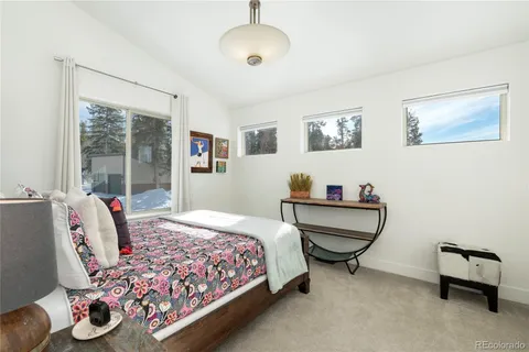 a bedroom with bed and a window