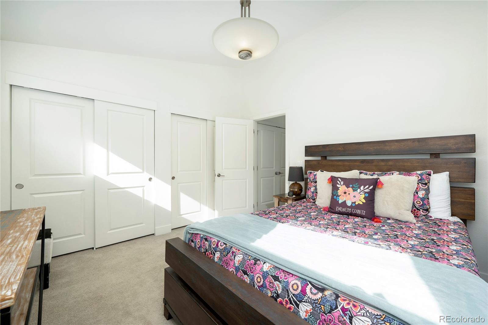 40 Journey Way Fraser, CO 80442 - Photo 22 of 41 a bedroom with a large bed and a chandelier
