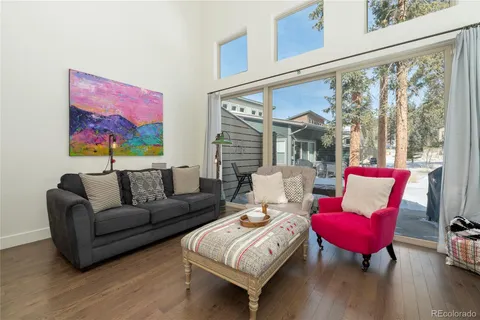 a living room with furniture fireplace and wooden floor