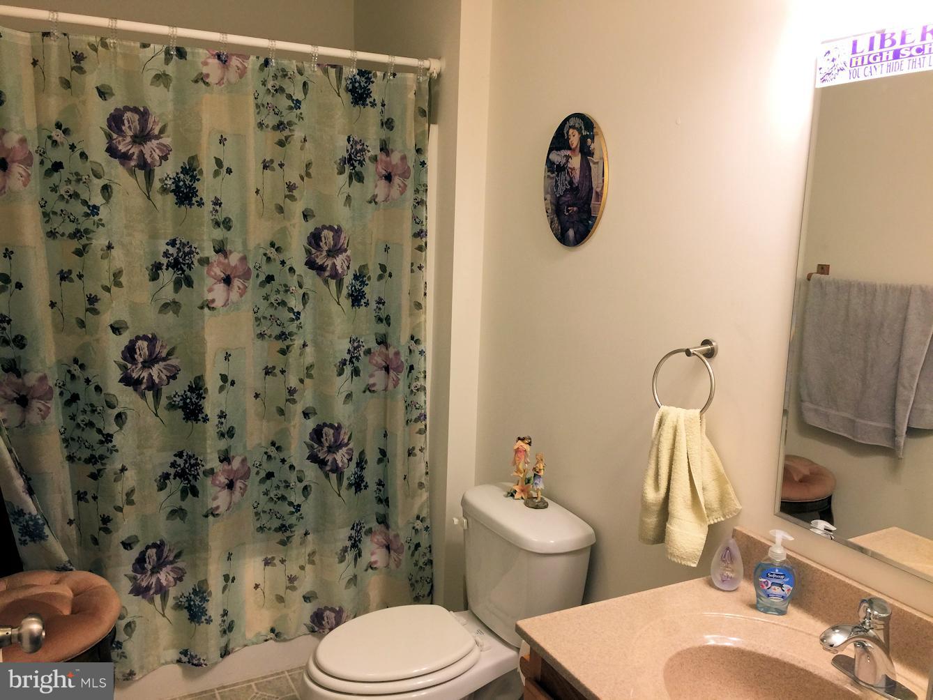 2441 Ridge Road Baltimore, MD 21244 - Photo 12 of 19 a bathroom with a sink toilet and shower
