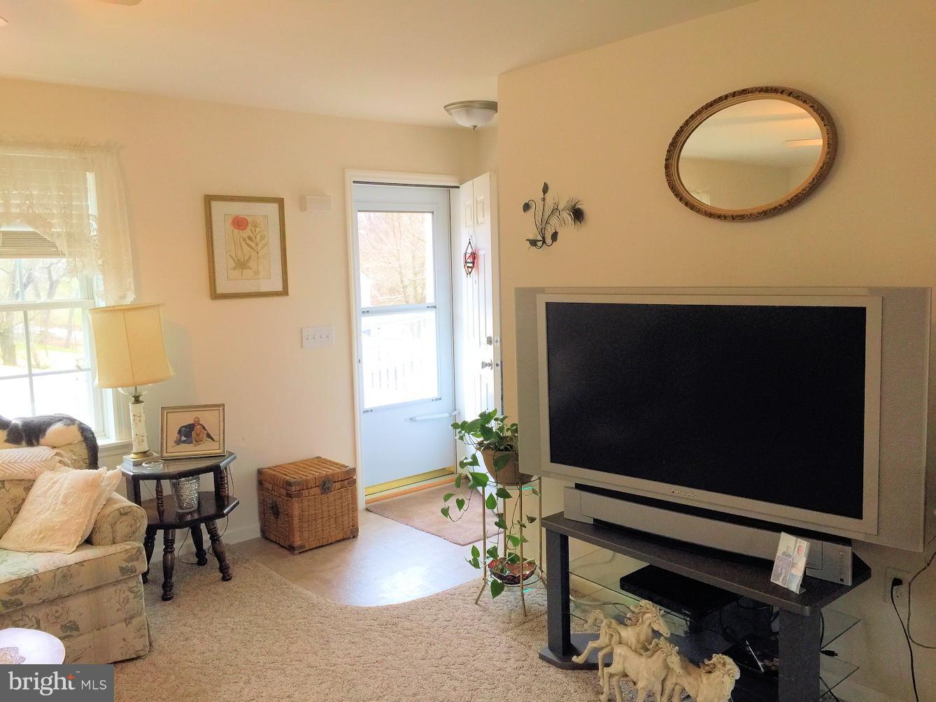 2441 Ridge Road Baltimore, MD 21244 - Photo 4 of 19 a living room with furniture a flat screen tv and a window