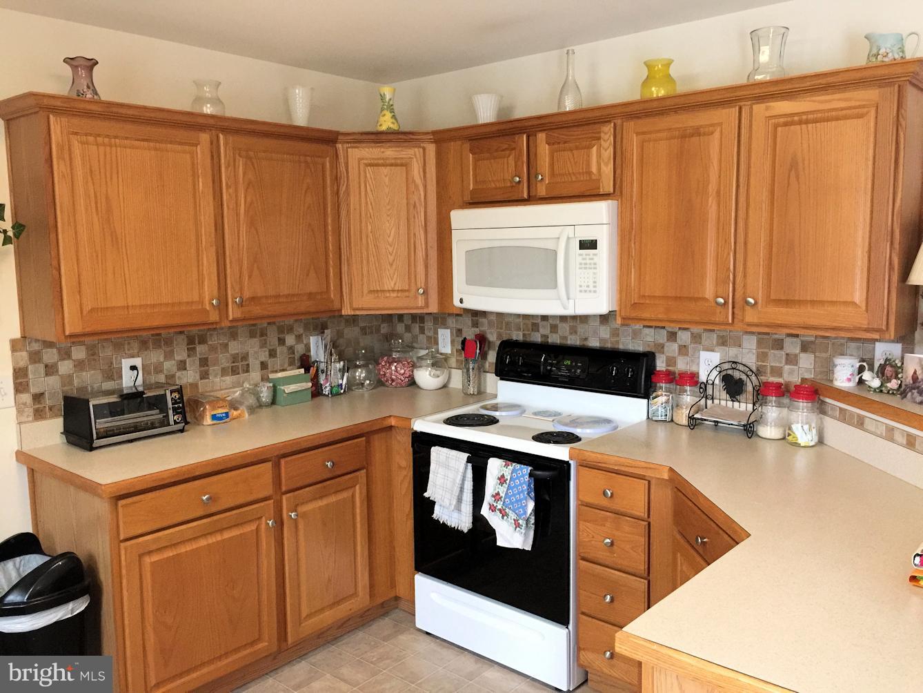 2441 Ridge Road Baltimore, MD 21244 - Photo 7 of 19 a kitchen with stainless steel appliances granite countertop a stove a sink and a microwave