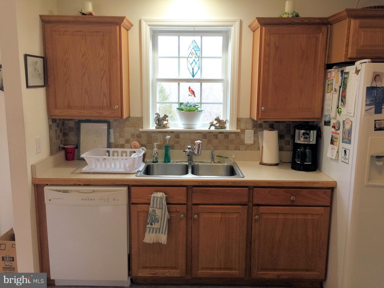 2441 Ridge Road Baltimore, MD 21244 - Photo 8 of 19 a kitchen with stainless steel appliances granite countertop a sink a refrigerator a cabinets and a counter space