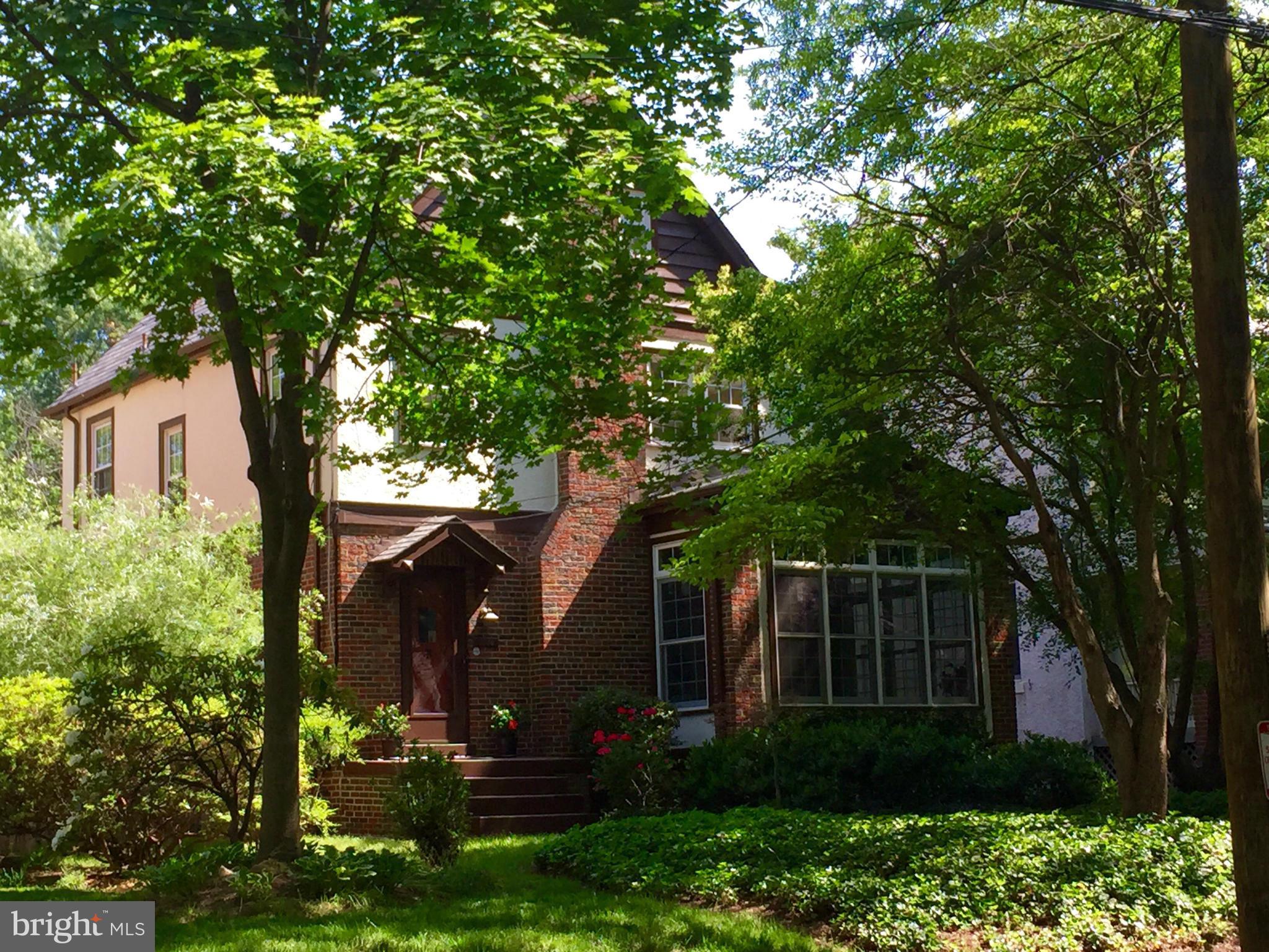a view of house with a tree in front of it