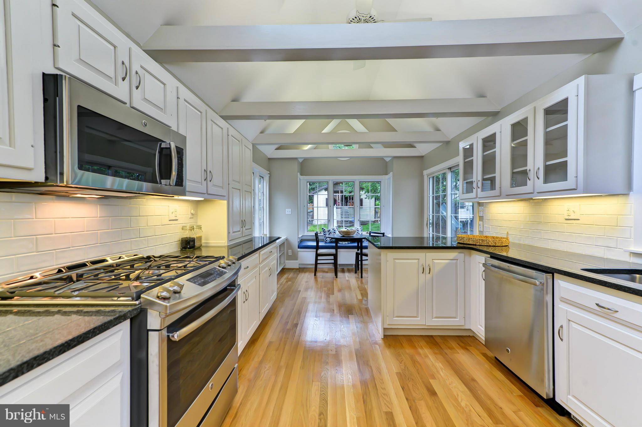 3339 Military Road Northwest Washington, DC 20015 - Photo 11 of 30 a kitchen with stainless steel appliances kitchen island granite countertop a stove and a wooden floors