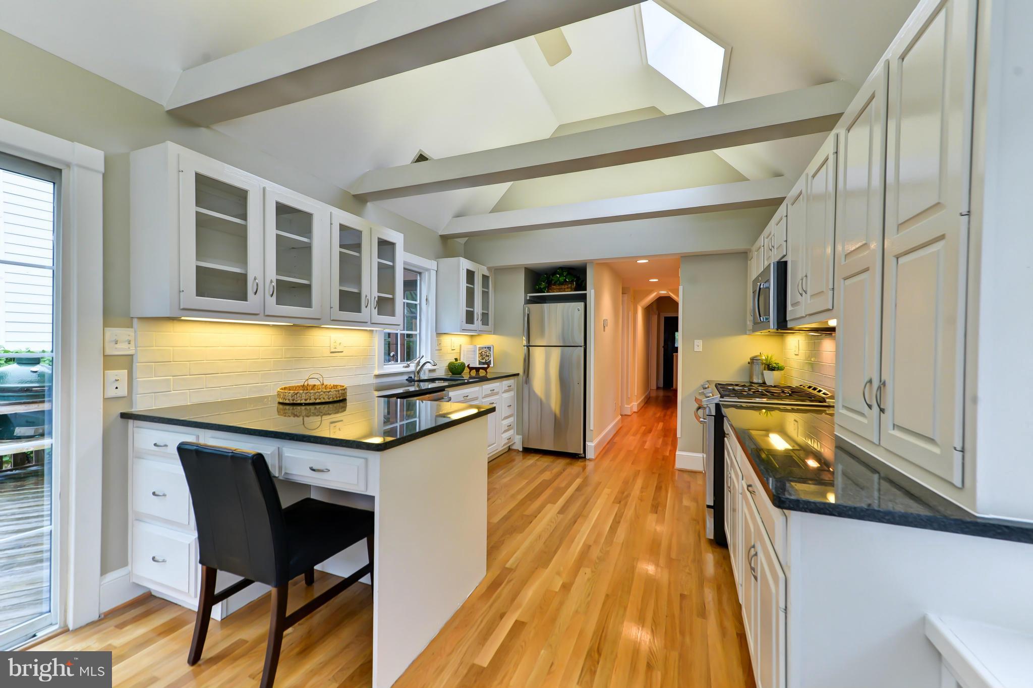 3339 Military Road Northwest Washington, DC 20015 - Photo 14 of 30 a kitchen with stainless steel appliances granite countertop sink stove top oven and cabinets