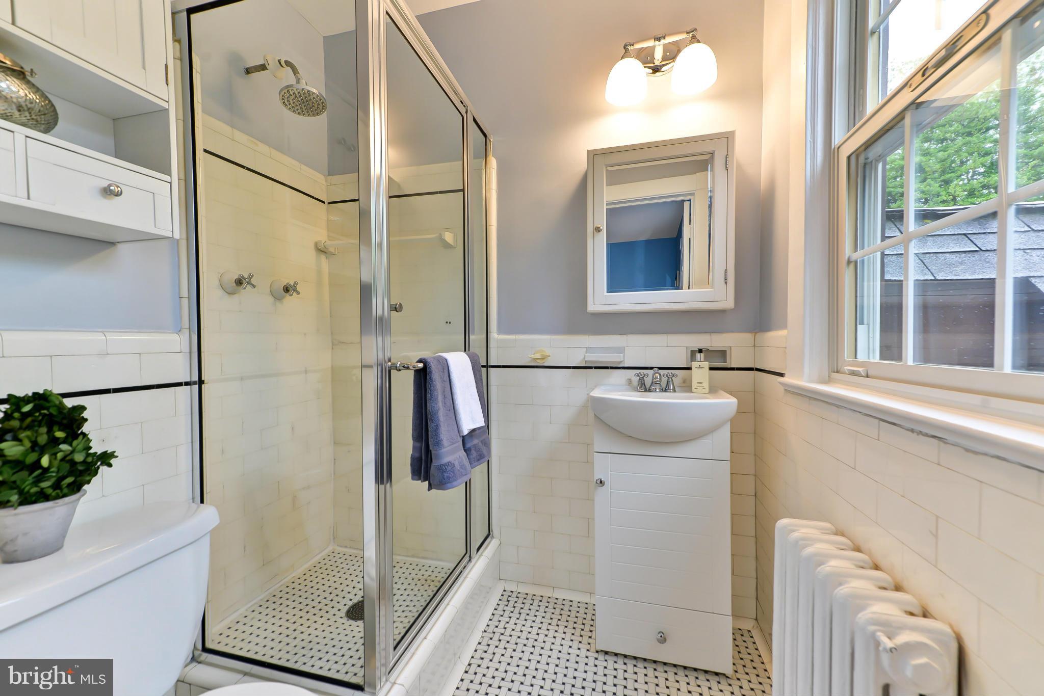 3339 Military Road Northwest Washington, DC 20015 - Photo 21 of 30 a bathroom with a sink a mirror and a shower