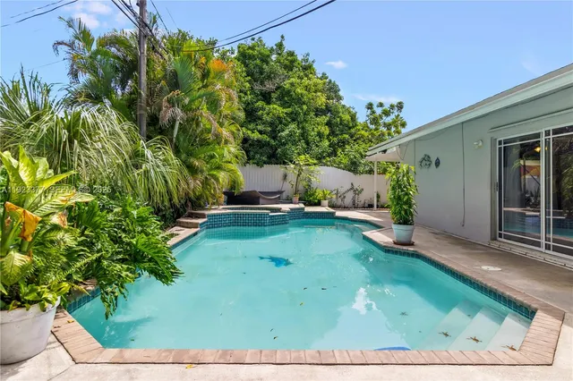 a view of a backyard with potted plants