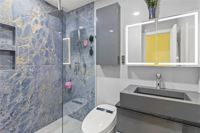 a bathroom with a sink toilet and shower