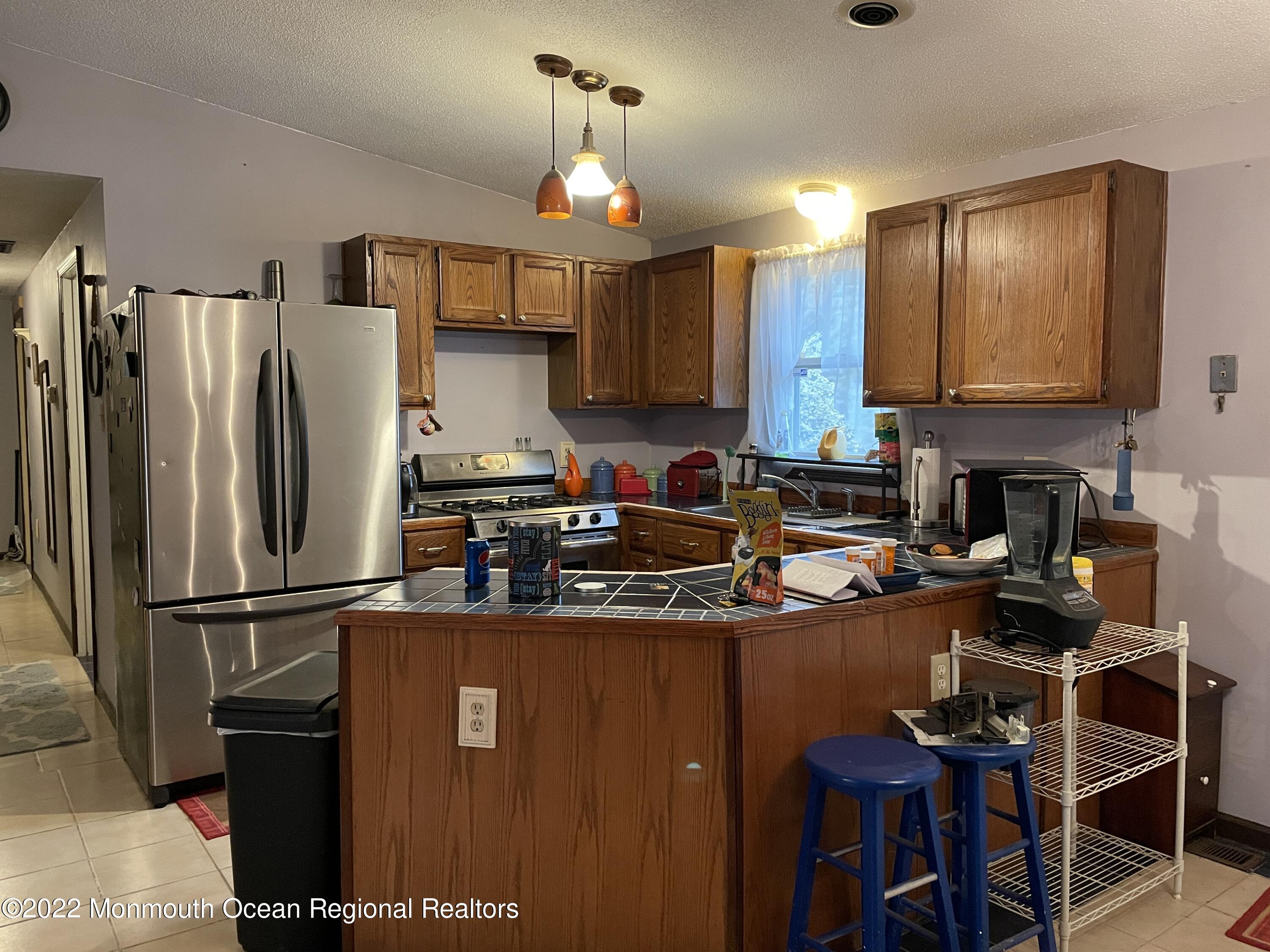 330 Ridge Road Browns Mills, NJ 08015 - Photo 2 of 33 a kitchen with stainless steel appliances granite countertop a refrigerator a stove a sink and a microwave