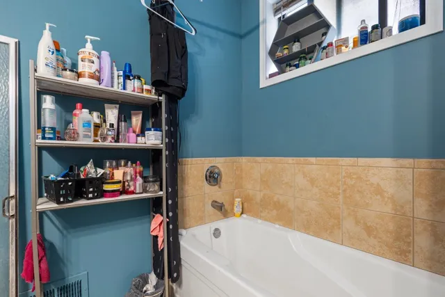 a bathroom with a shower curtain and a window