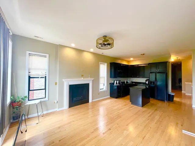 a kitchen with kitchen island a counter top space a sink cabinets and appliances