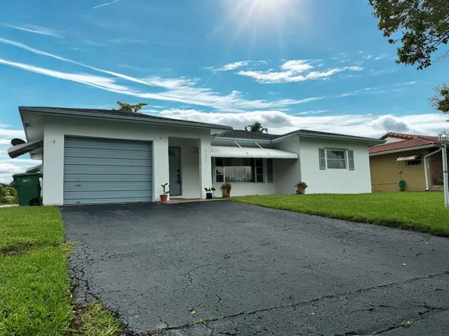 a view of a house with a yard and garage