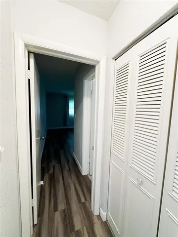 a view of a livingroom with wooden floor and a window