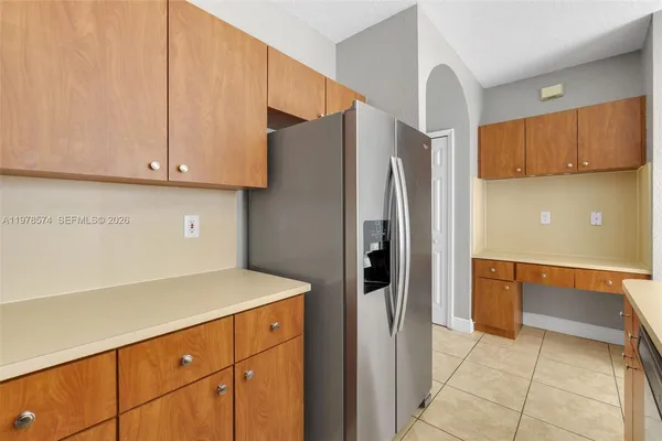 a kitchen with stainless steel appliances a refrigerator and a stove top oven