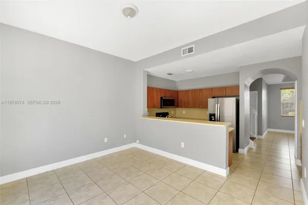 a kitchen with cabinets and a refrigerator