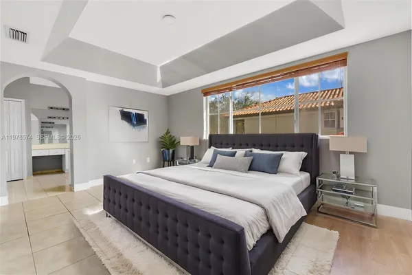 a bedroom with a large bed and a large window