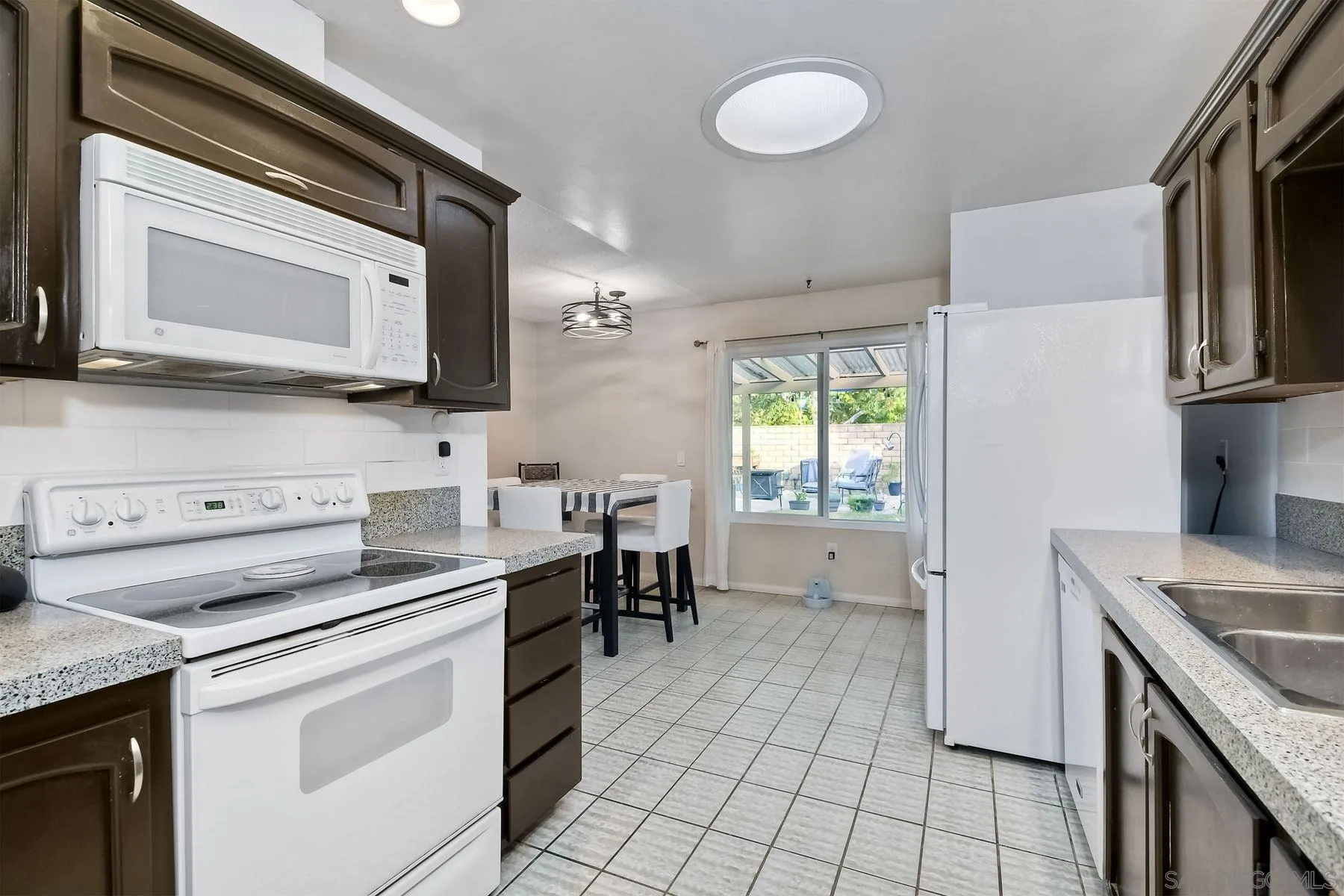 14051 Olive Meadows Place Poway, CA 92064 - Photo 11 of 33 a kitchen with a stove microwave and a sink