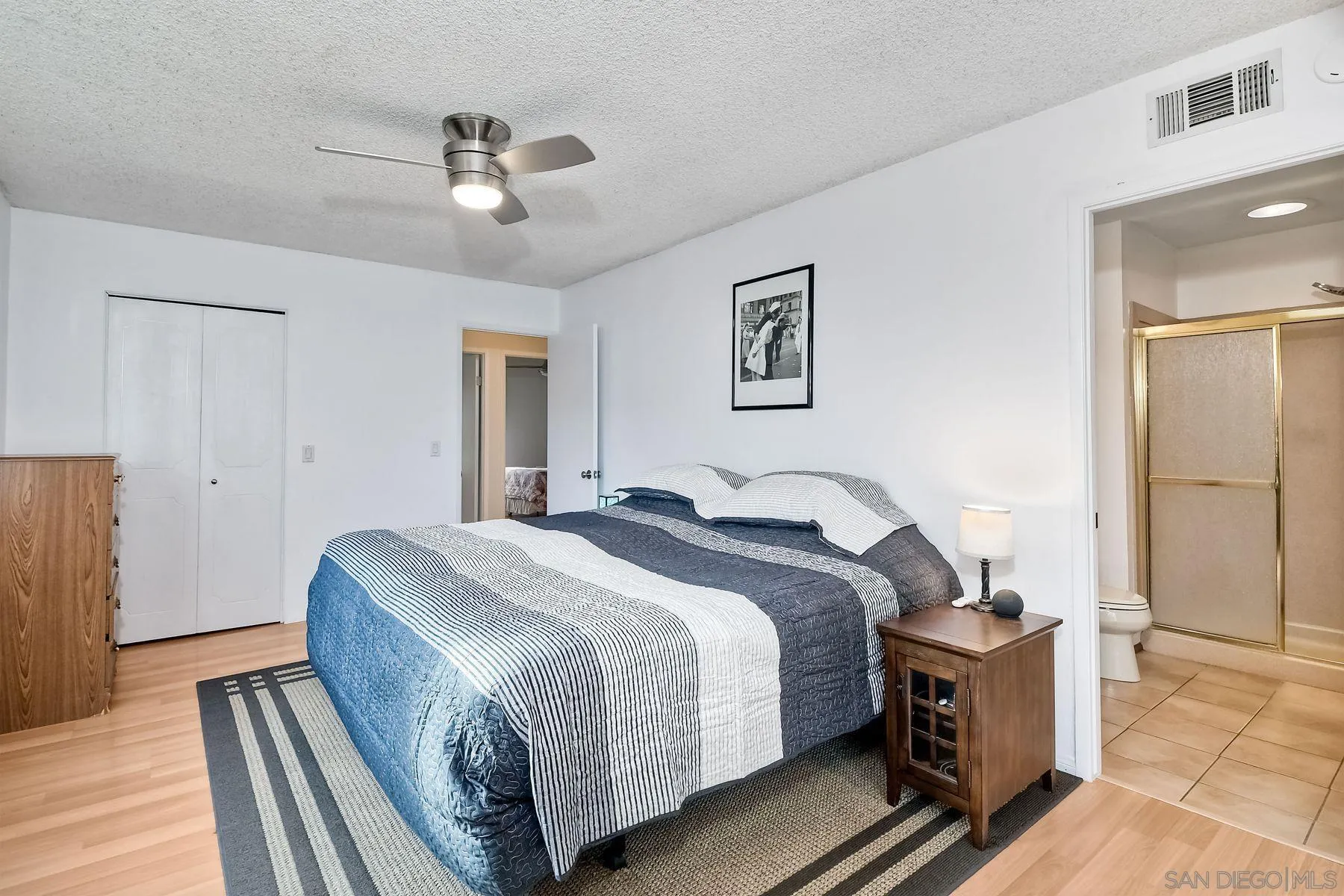 14051 Olive Meadows Place Poway, CA 92064 - Photo 20 of 33 a bed room with a bed and a chandelier