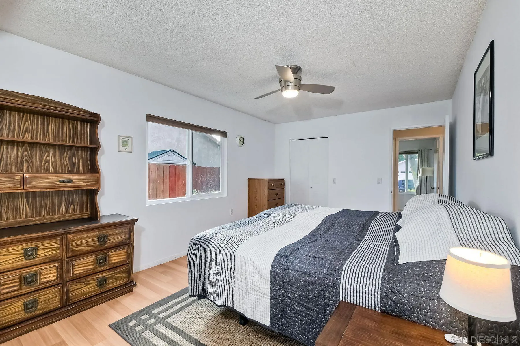 14051 Olive Meadows Place Poway, CA 92064 - Photo 21 of 33 a bedroom with a bed wooden floor and window