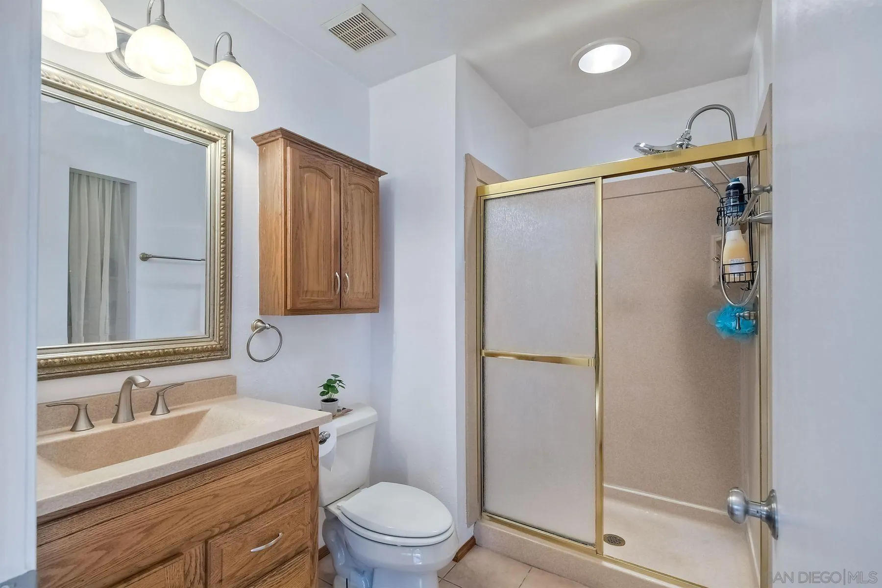 14051 Olive Meadows Place Poway, CA 92064 - Photo 22 of 33 a bathroom with a granite countertop sink toilet and shower