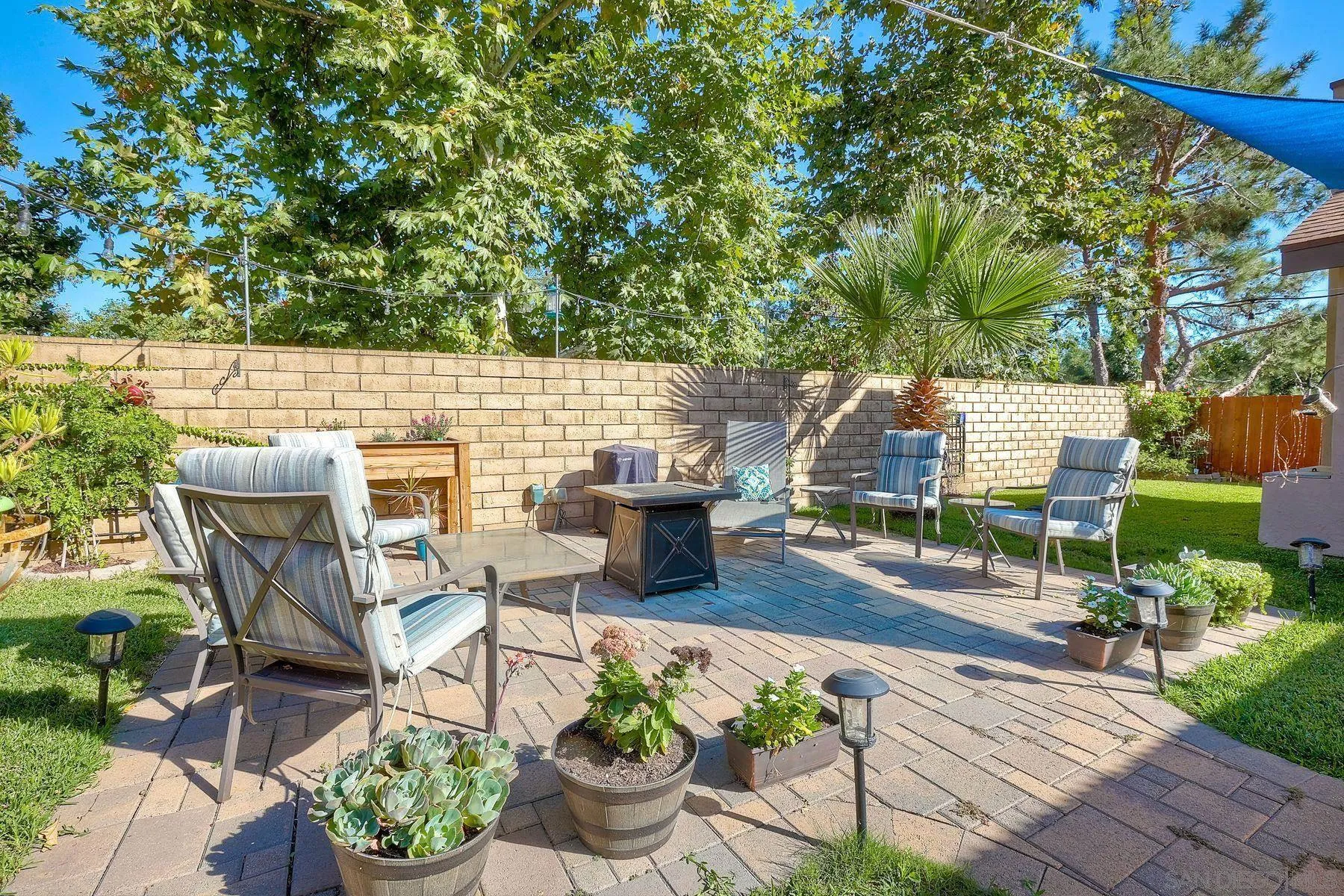 14051 Olive Meadows Place Poway, CA 92064 - Photo 28 of 33 a roof deck with table and chairs potted plants and a large tree