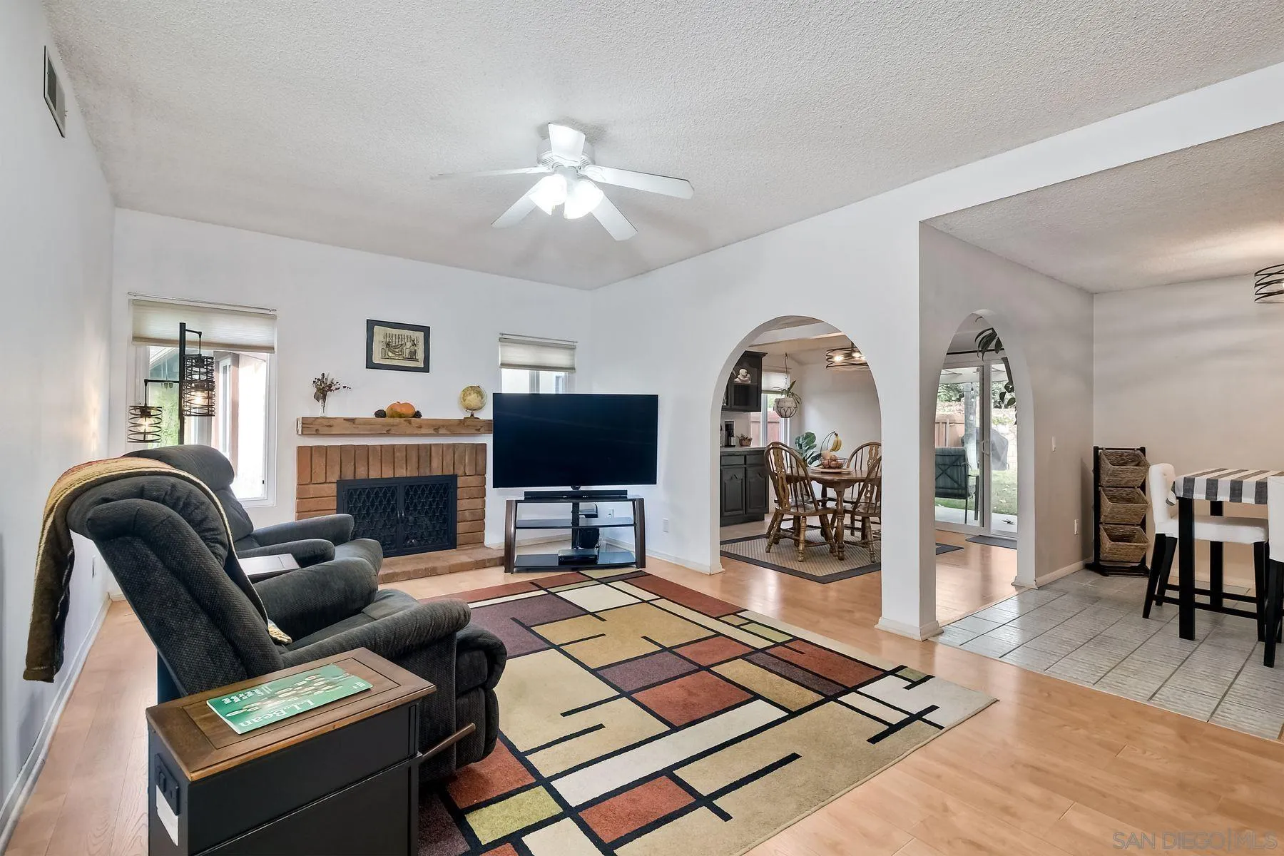 14051 Olive Meadows Place Poway, CA 92064 - Photo 4 of 33 a living room with furniture a flat screen tv and a fireplace