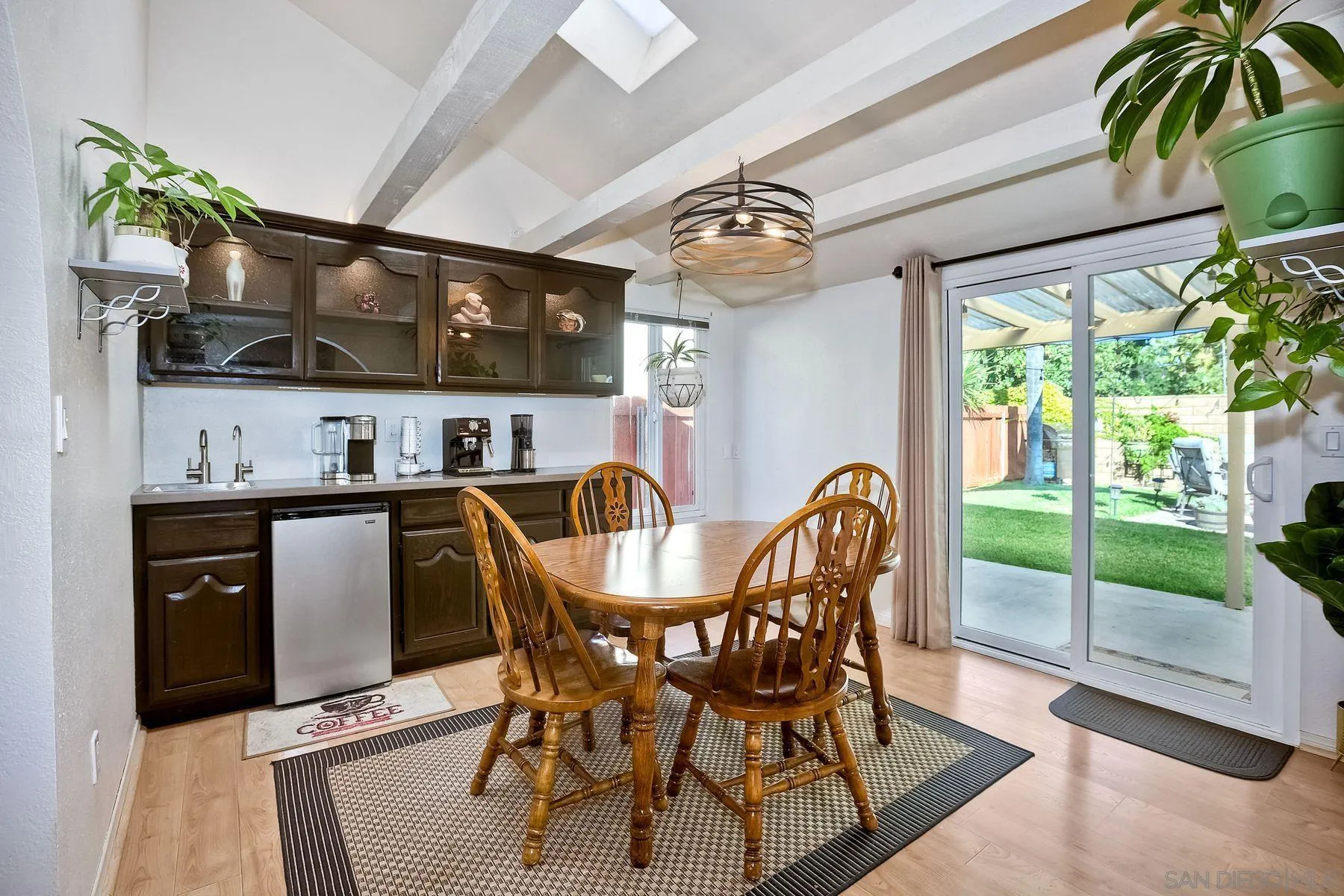 14051 Olive Meadows Place Poway, CA 92064 - Photo 6 of 33 a dining room with furniture a floor to ceiling window and wooden floor