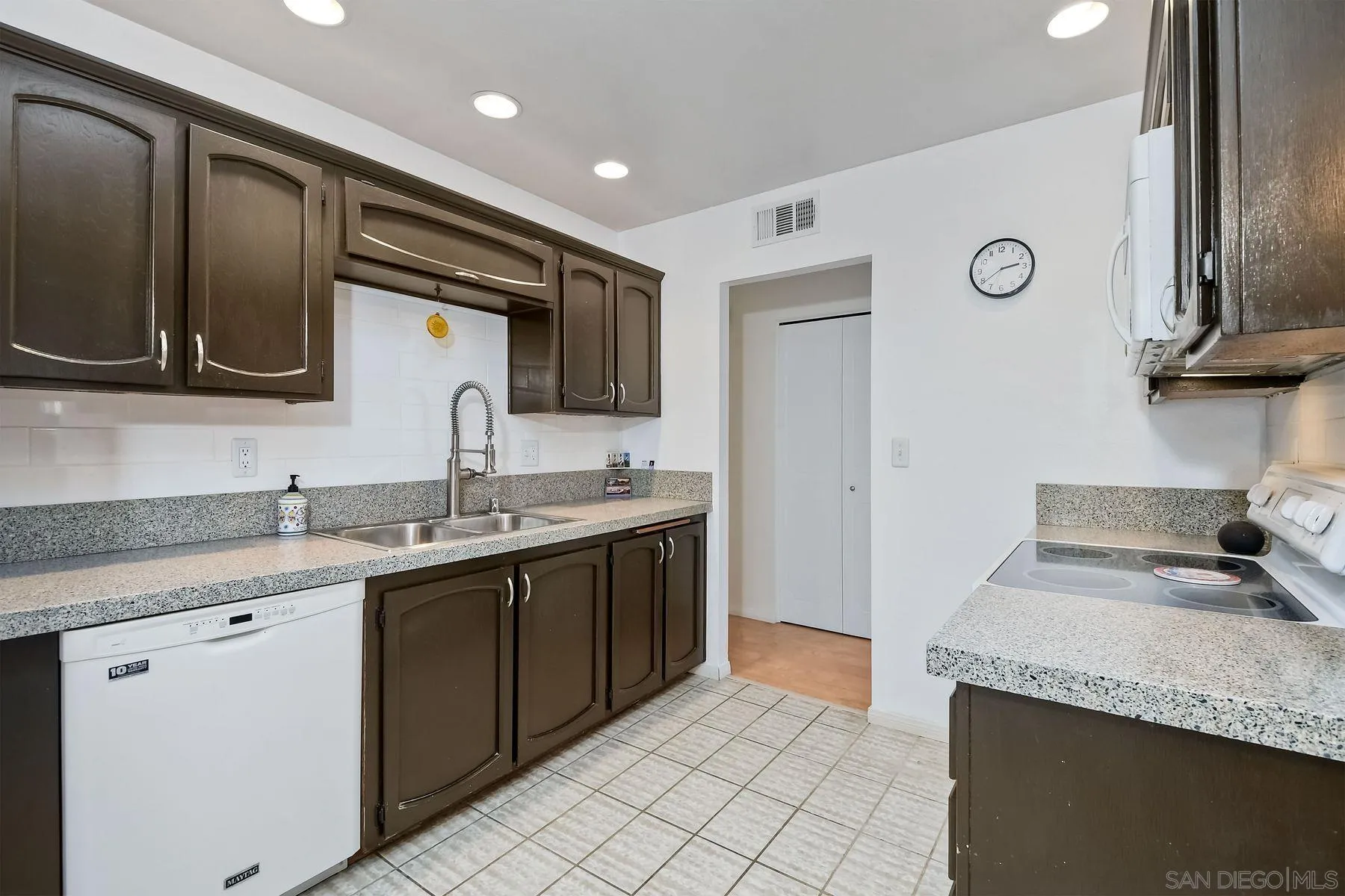 14051 Olive Meadows Place Poway, CA 92064 - Photo 10 of 33 a kitchen with stainless steel appliances granite countertop a sink and a stove