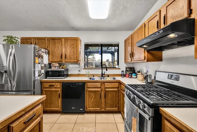 a kitchen with a stove sink and cabinets
