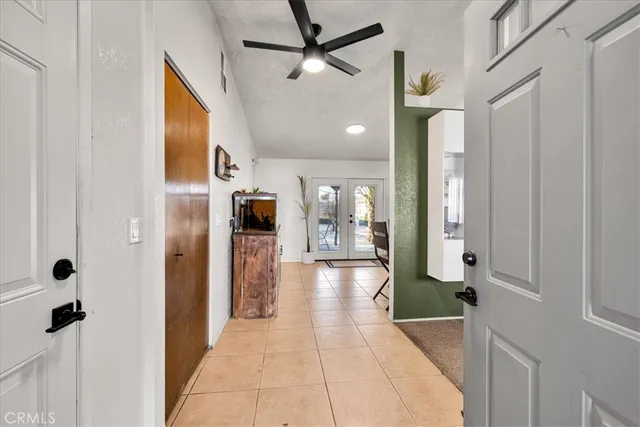 a view of a hallway with a dining table and chairs