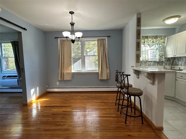 a view of a dining room with furniture window and wooden floor
