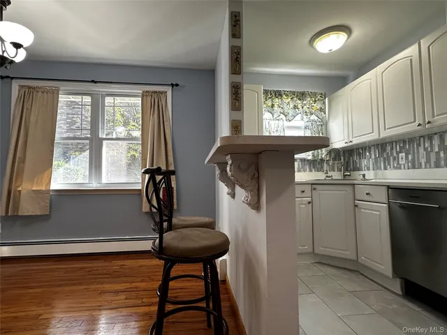 a kitchen with a window a refrigerator and cabinetry