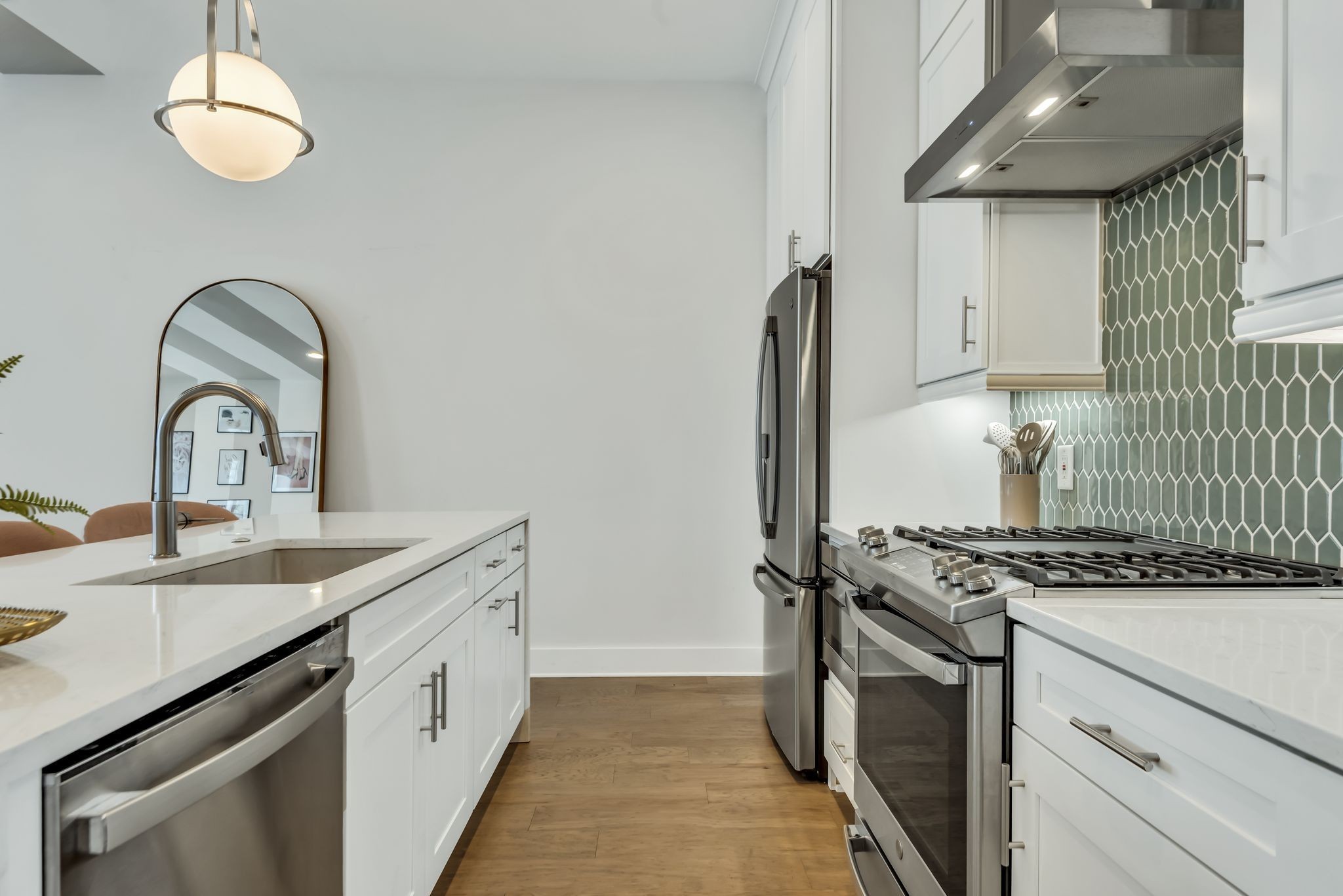 2176 Carson Street, Unit 24 Nashville, TN 37211 - Photo 21 of 36 a kitchen with stainless steel appliances granite countertop a sink a stove and a wooden floors