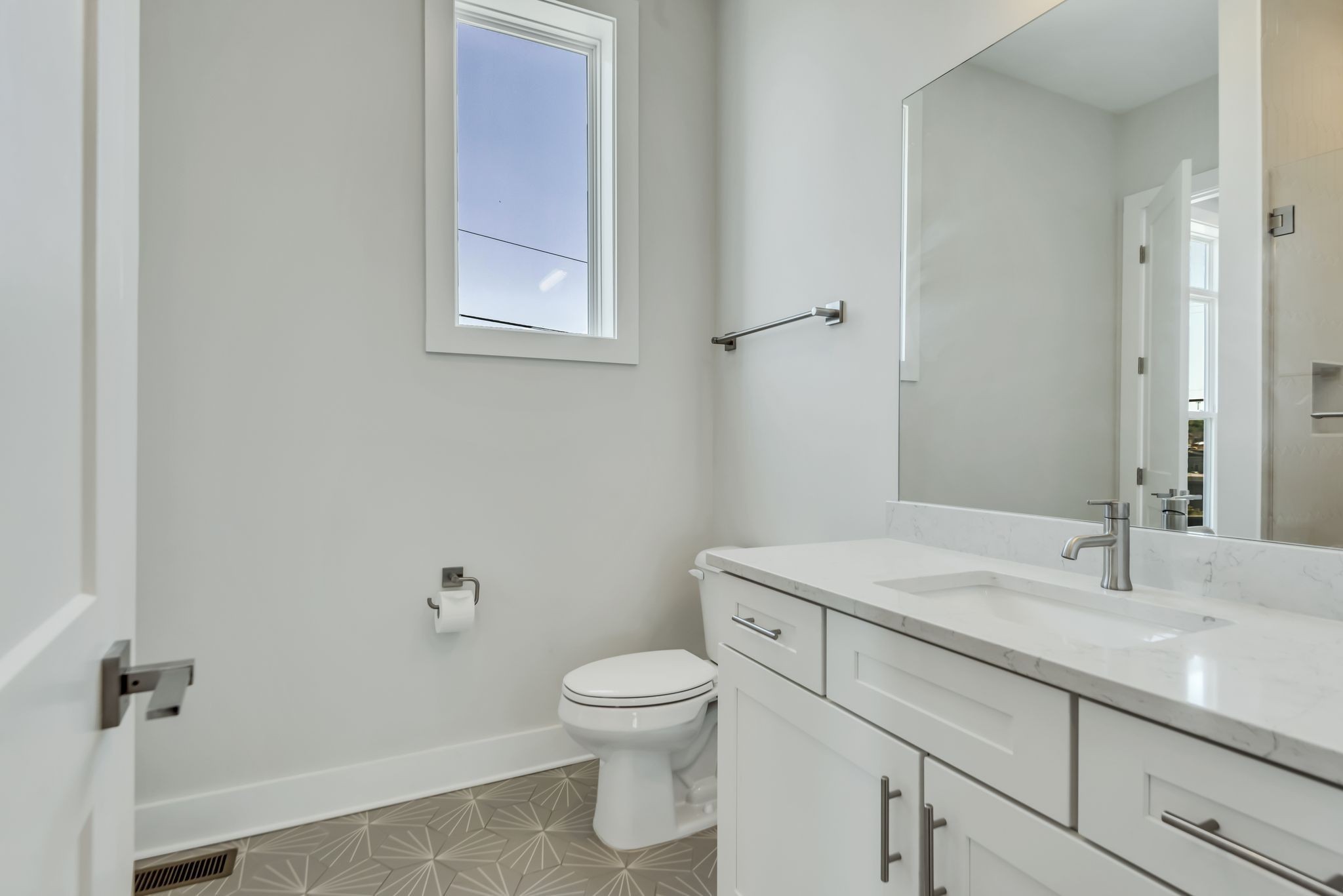 2176 Carson Street, Unit 24 Nashville, TN 37211 - Photo 25 of 36 a bathroom with a toilet sink vanity and mirror