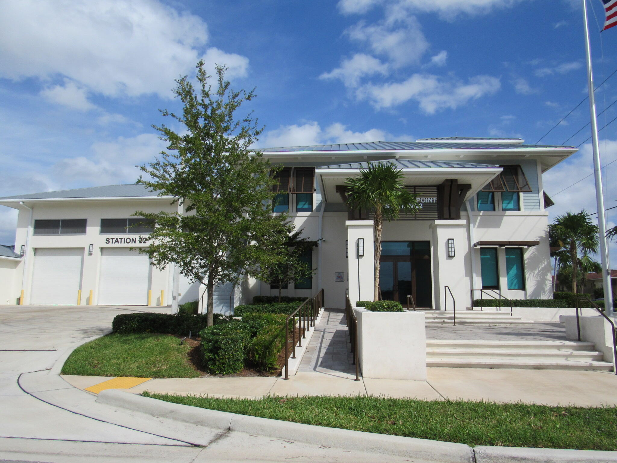1911 Northeast 27th Court, Unit 13 Lighthouse Point, FL 33064 - Photo 52 of 61 a front view of a house with garden