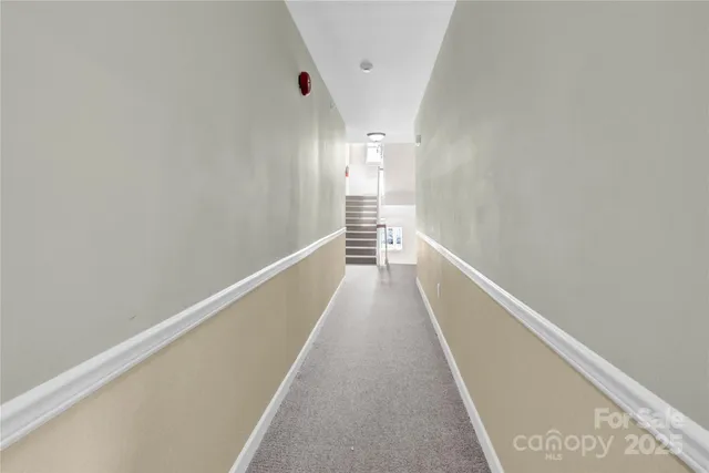 a view of a car parked in front of a white house