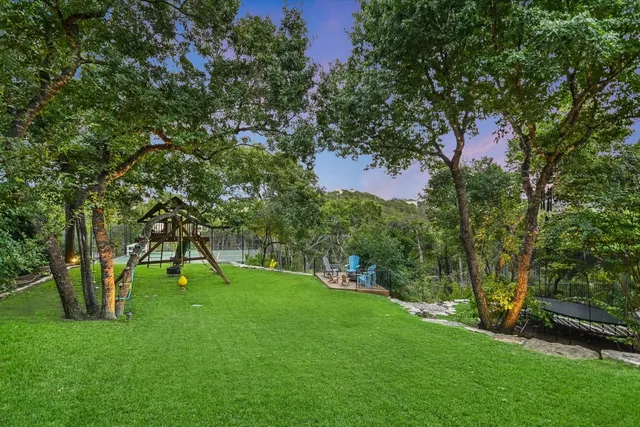 a view of green field with a tree