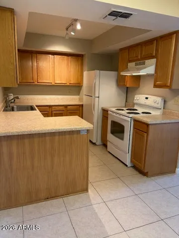 a kitchen with a stove sink and cabinets