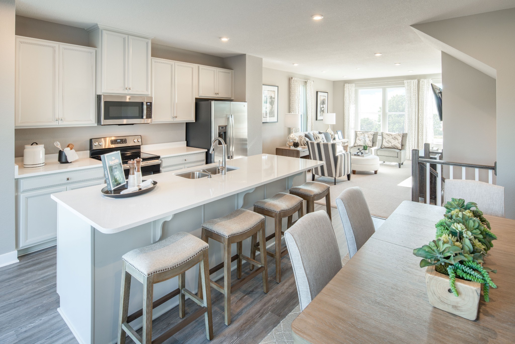 322 Poplar Loop Antioch, TN 37013 - Photo 6 of 20 a kitchen with stainless steel appliances granite countertop a table chairs microwave and sink