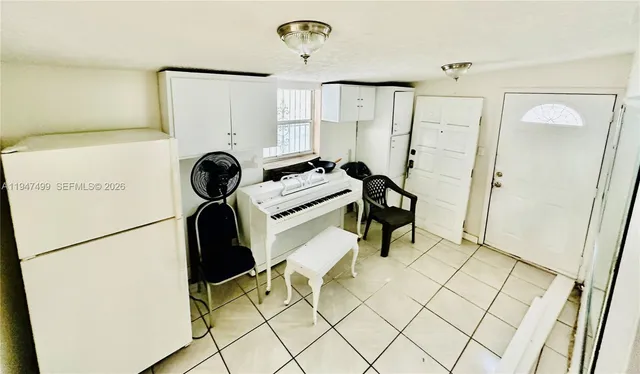 a view of a kitchen with a refrigerator and a stove top oven