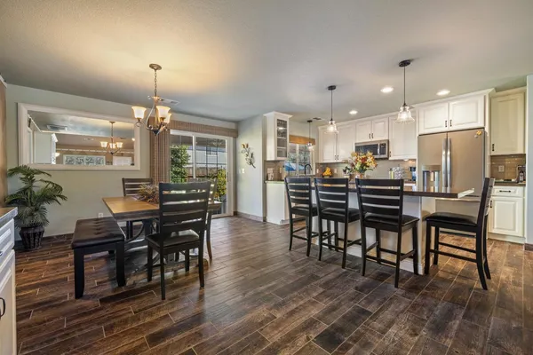 a view of a dining room with furniture and wooden floor