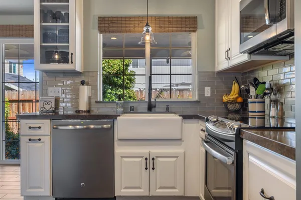 a kitchen with stainless steel appliances granite countertop a stove and a sink