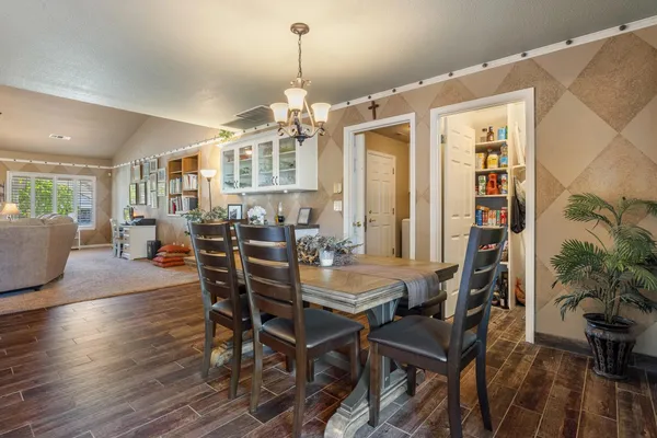 a view of a dining room with furniture and wooden floor