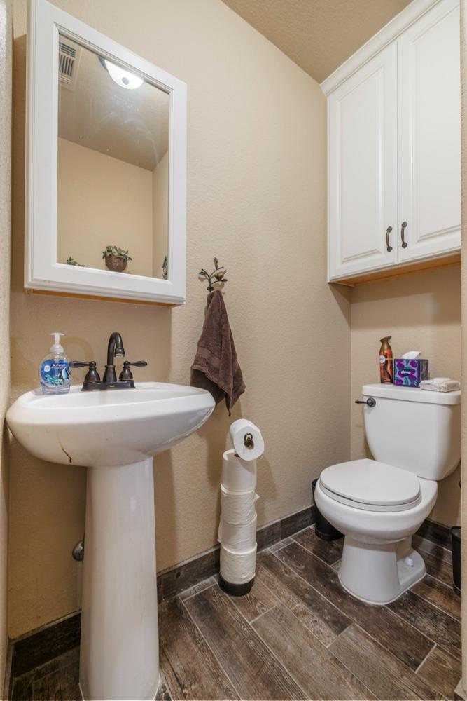 1084 Eastburg Court Ripon, CA 95366 - Photo 17 of 46 a bathroom with a toilet sink and mirror