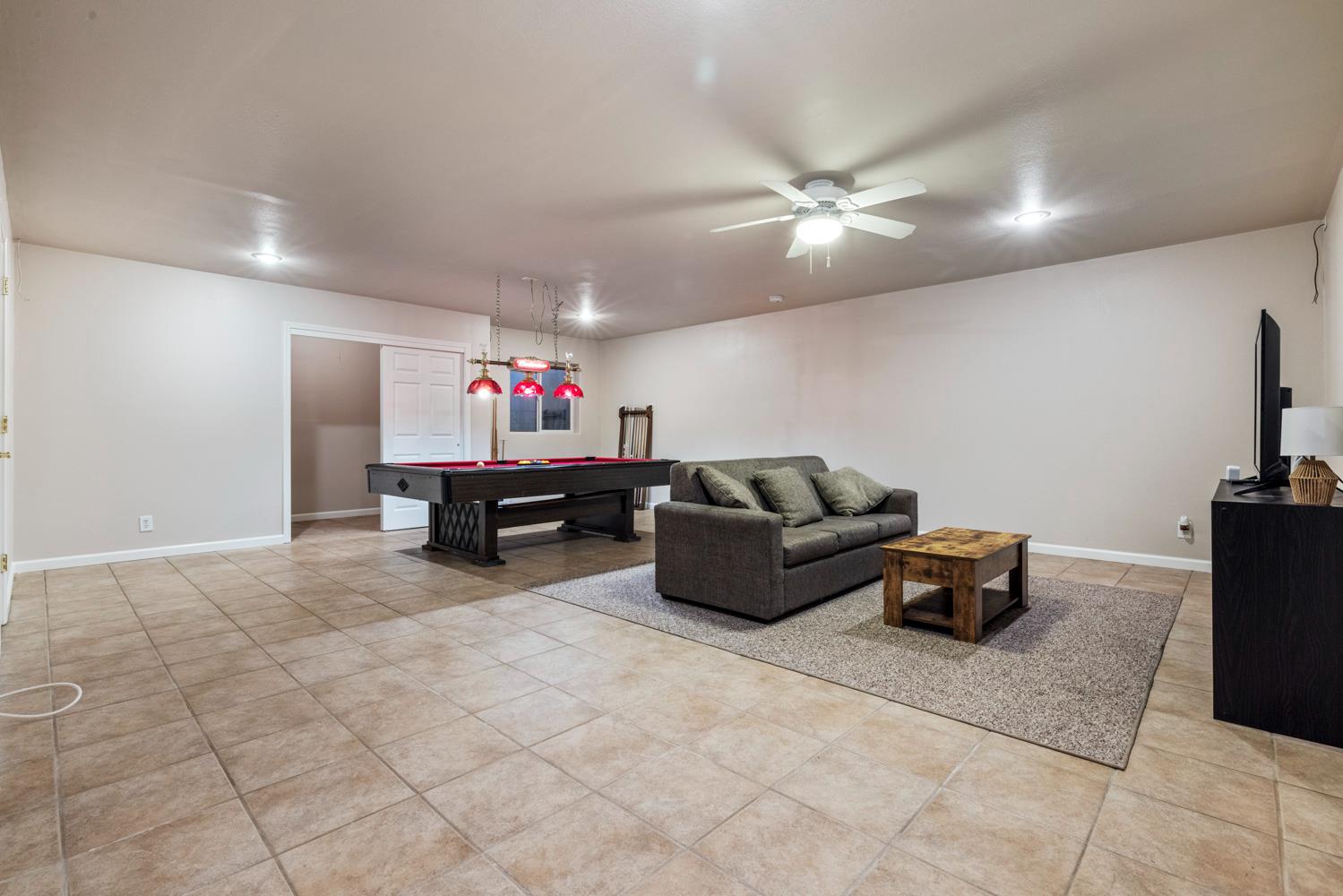 1084 Eastburg Court Ripon, CA 95366 - Photo 18 of 46 a living room with furniture and a chandelier