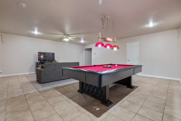 a room with pool table and flat screen tv