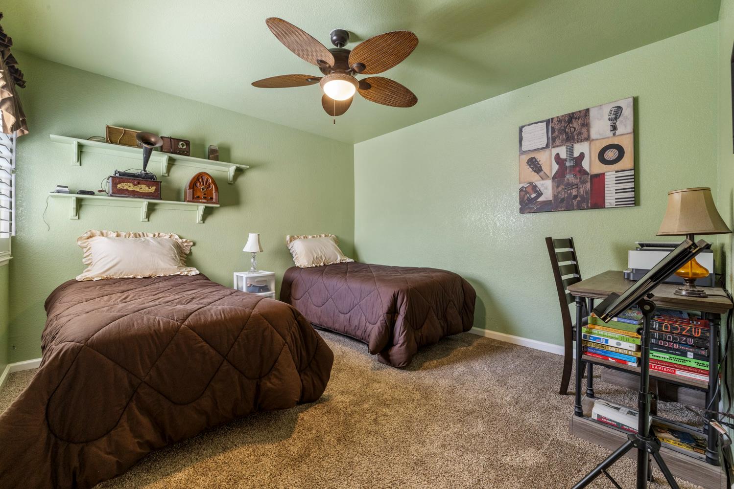 1084 Eastburg Court Ripon, CA 95366 - Photo 24 of 46 a bedroom with two beds and a chandelier