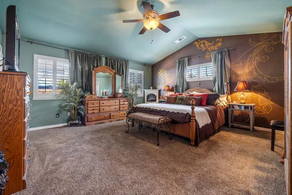 a bedroom with a bed window and dresser