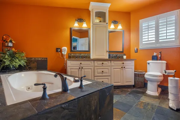 a bathroom with a tub sink and mirror